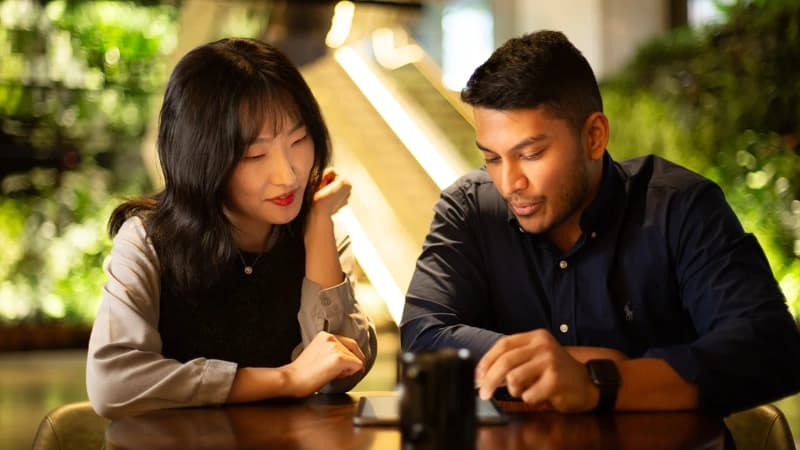 Two colleagues reviewing a tablet in the office