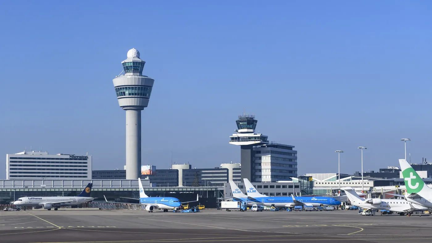 Airplanes at Amsterdam Schiphol Airport in The Netherlands during a springtime sunset.