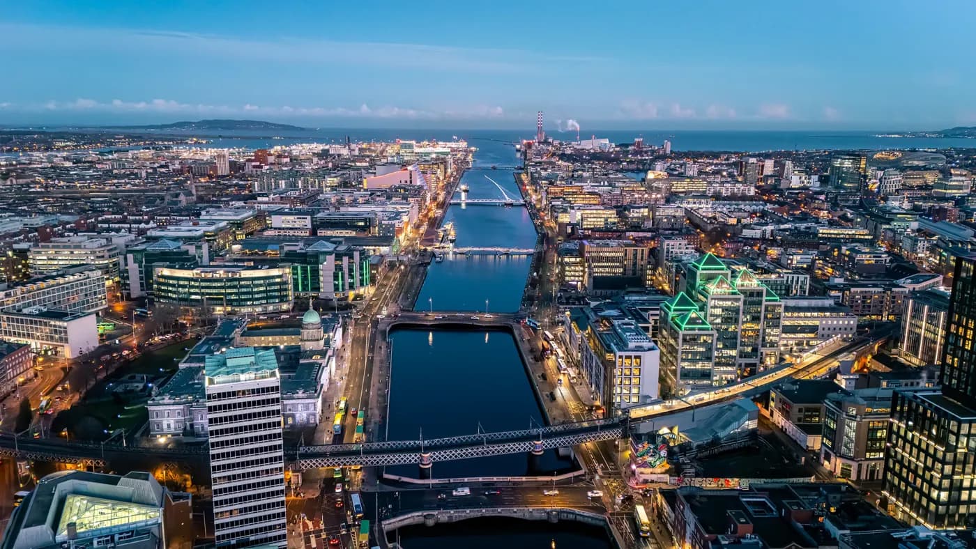 Aerial view of busy city center buildings and traffic at night, Aerial view of the river Liffey and city center Dublin Ireland at night.