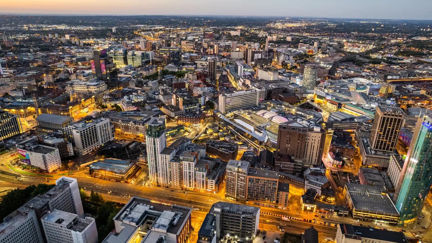 Aerial view over the city center by night including central train station