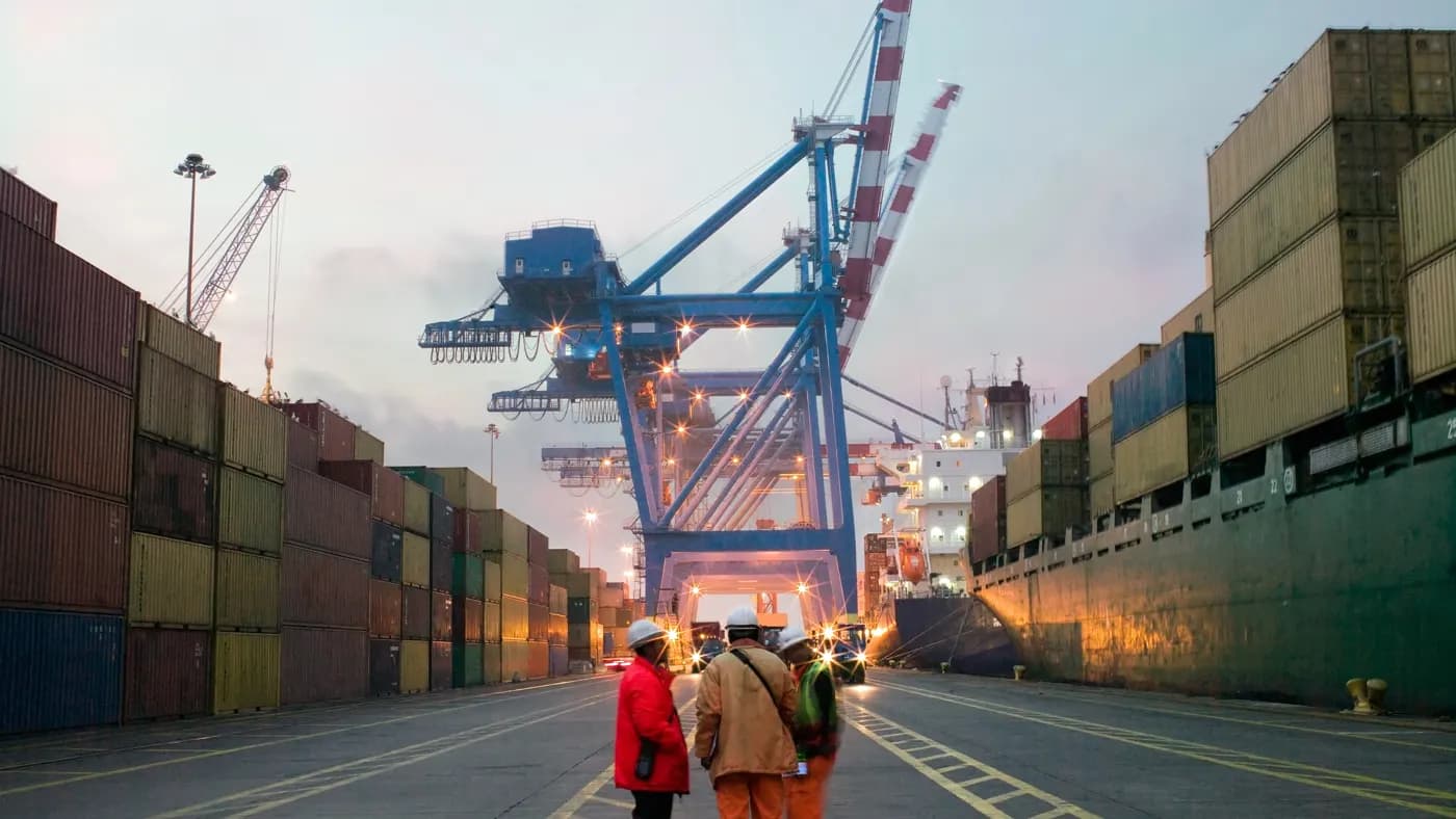 Workers talking in a shipping yard