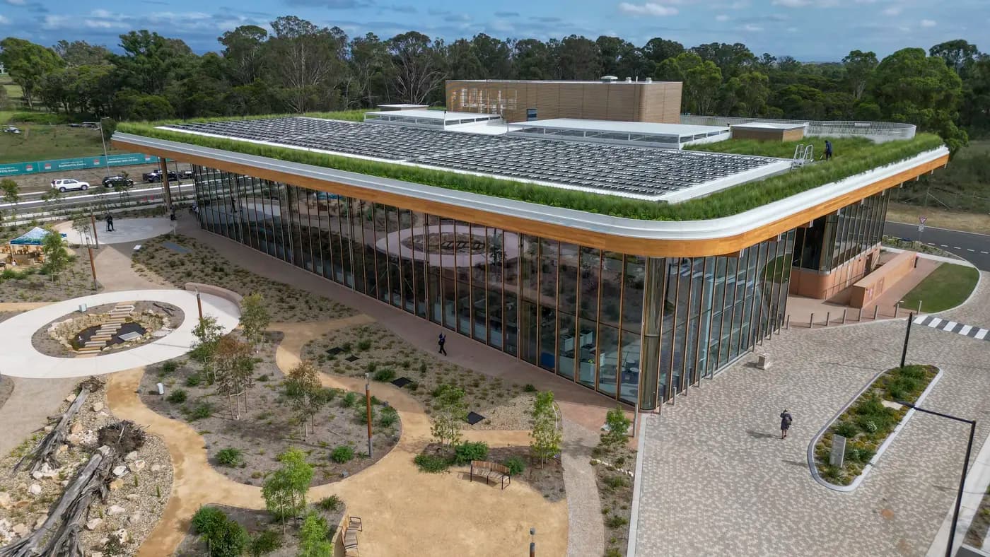 BDA first building with green grass on roof and glass windows.
